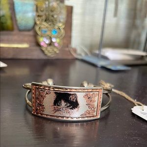 Copper bracelet with cat design.